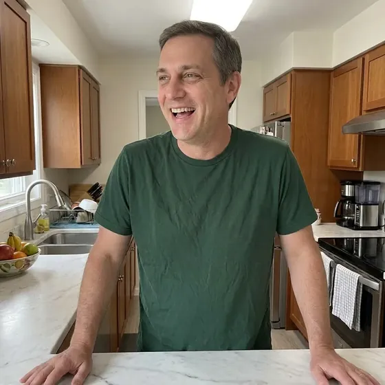 Man smiling in his kitchen